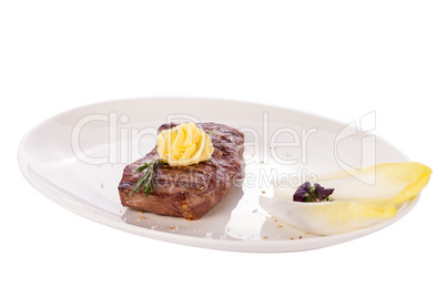 Grilled beef steak topped with butter and rosemary