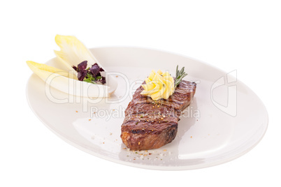 Grilled beef steak topped with butter and rosemary