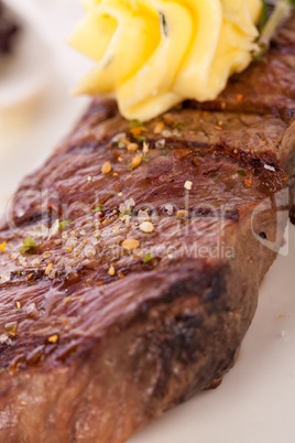 Grilled beef steak topped with butter and rosemary