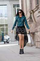 young attractive brunette woman walking on street city life