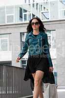 young attractive brunette woman walking on street city life