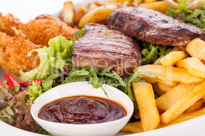 Platter of mixed meats, salad and French fries