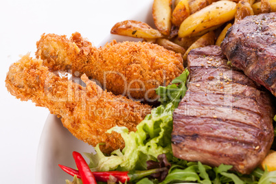 Platter of mixed meats, salad and French fries