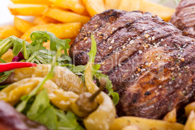 Platter of mixed meats, salad and French fries