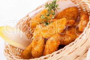 Crumbed chicken nuggets in a basket