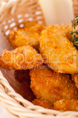 Crumbed chicken nuggets in a basket