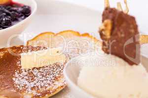 tasty sweet pancakes with vanilla icecream and topping