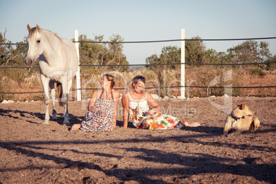 two woman horse and dog outdoor in summer happy