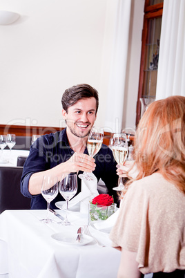 happy smiling couple in restaurant celebrate