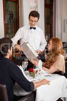 Waiter serving a couple in a restaurant