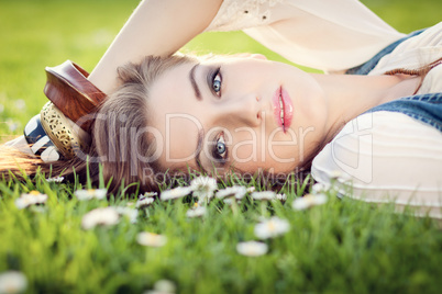 beautiful woman lying in grass in summer