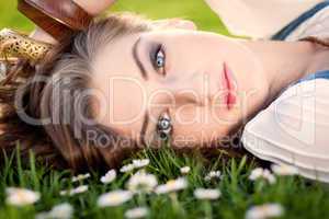 beautiful woman lying in grass in summer