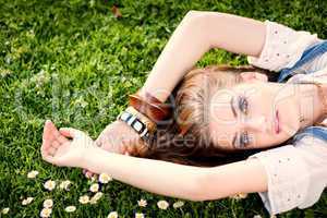 beautiful woman lying in grass in summer