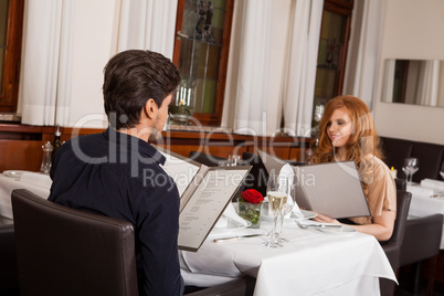 Waiter serving a couple in a restaurant