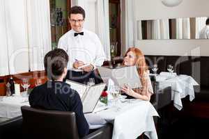 man and woman for dinner in restaurant
