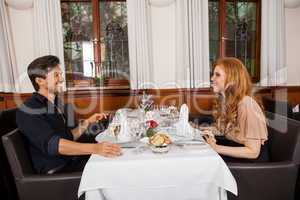 Waiter serving a couple in a restaurant