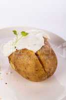 Baked jacket potato with sour cream sauce