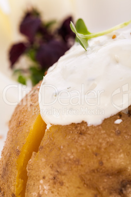 Baked jacket potato with sour cream sauce