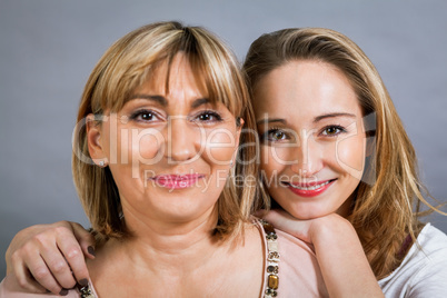 smiling middle-aged young mother and daughter