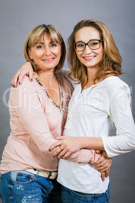 smiling middle-aged young mother and daughter