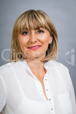 Smiling confident middle-aged blond woman