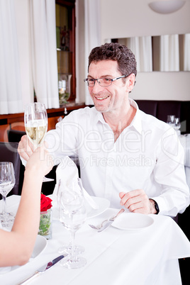 happy smiling couple in restaurant celebrate