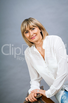 Smiling confident middle-aged blond woman