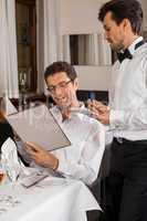 Waiter serving a couple in a restaurant