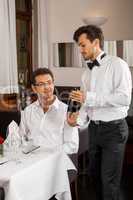 Waiter serving a couple in a restaurant