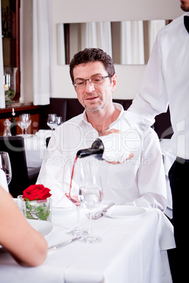 couple drinking red wine in restaurant