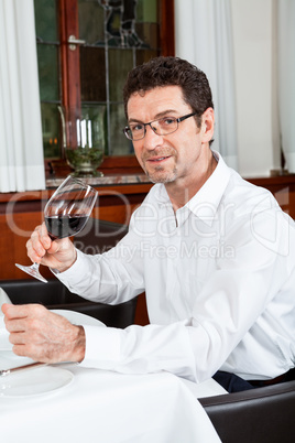 couple drinking red wine in restaurant