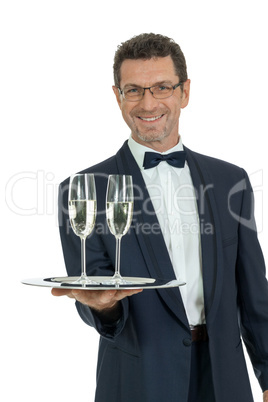 adult male waiter serving two glass of champagne isolated