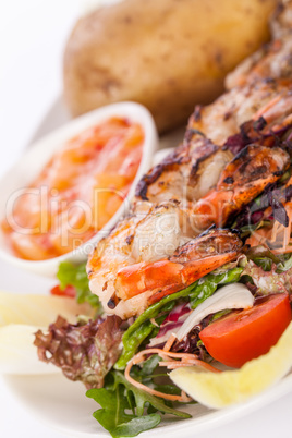 Grilled prawns with endive salad and jacket potato