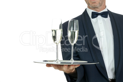 adult male waiter serving two glass of champagne isolated