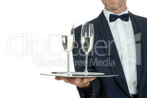 adult male waiter serving two glass of champagne isolated