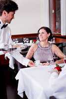 waiter serve fresh espresso for happy couple