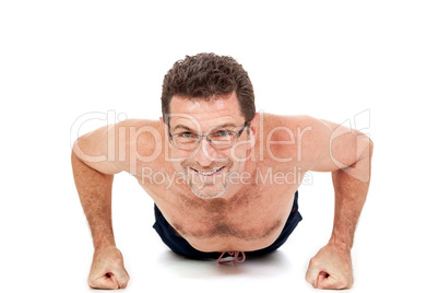 adult smiling man doing workout pushups isolated