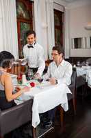 Waiter happily accommodating couple