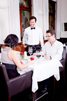 waiter serve fresh espresso for happy couple