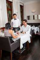 Waiter happily accommodating couple