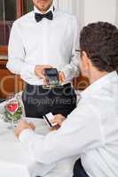 dinner in restaurant man and woman pay by credit card