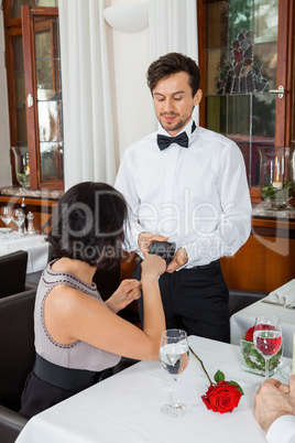 dinner in restaurant man and woman pay by credit card