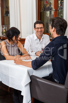 Waiter happily accommodating couple