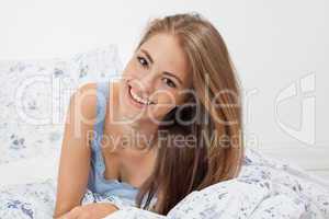 young brunette woman lying in bed sleeping morning