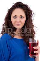 beautiful smiling brunette woman is drinking red juice