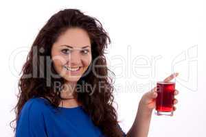 beautiful smiling brunette woman is drinking red juice