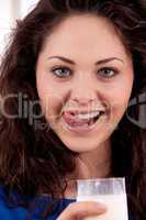 beautiful smiling woman is drinking milk