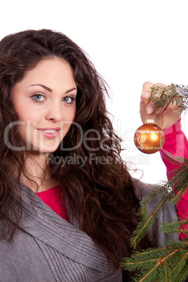 beautiful brunette woman is decorating a christmas tree beautiful brunette woman is decorating a christmas tree