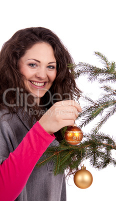 beautiful brunette woman is decorating a christmas tree