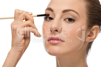 doing the makeup brown eyeshadow on beautiful eyes